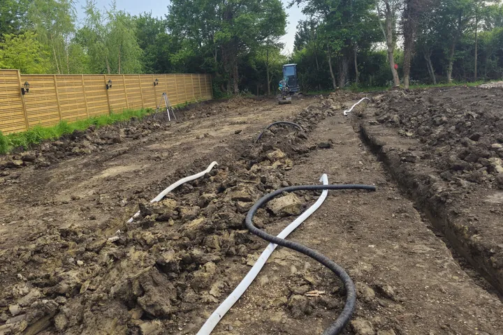 Excavated drainage trench and pipe installation